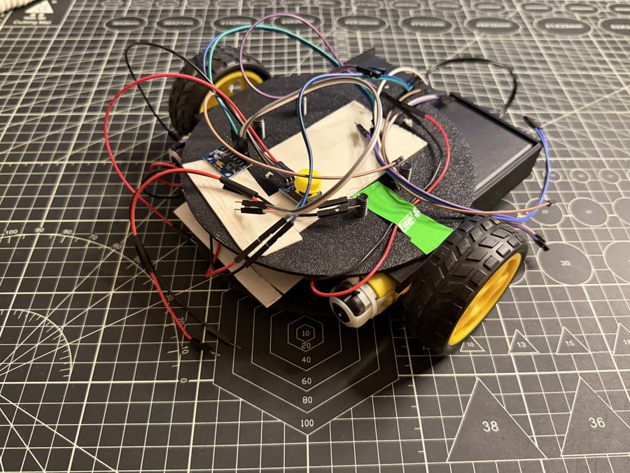 Black-chassis robot car with stacked round decks, a GY-521 motion sensor module, and a battery pack.